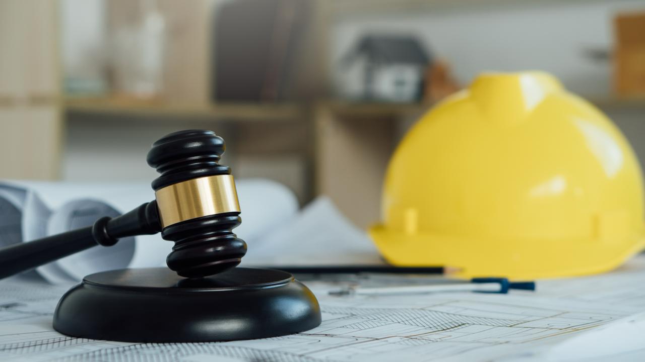 Gavel and hard hat on construction blueprints — NJ DOL enforcement